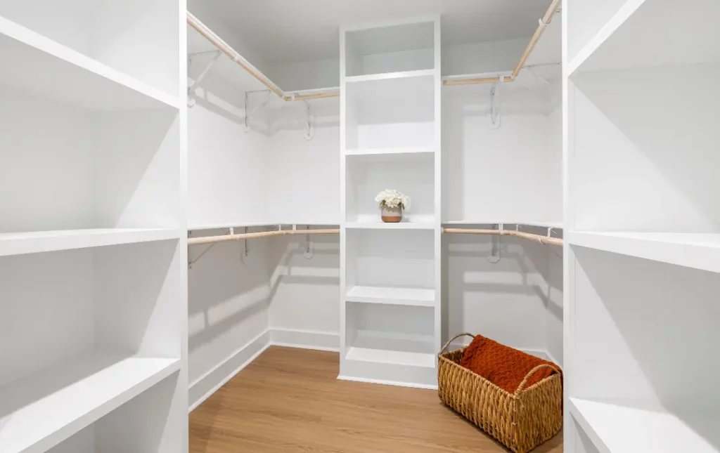 White closet with custom shelves and hangers for storage