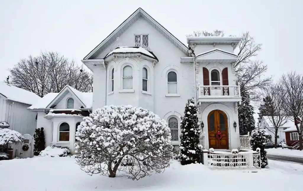 3 story white home in winter with snow
