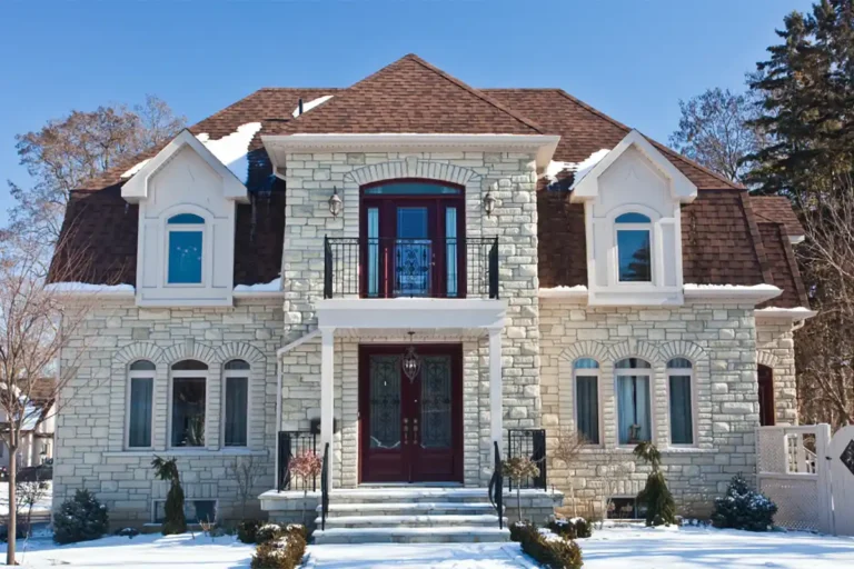Front of large modern home with stone facing