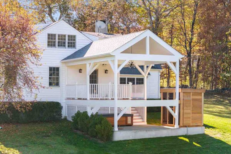 White suburban home with covered rear porch.