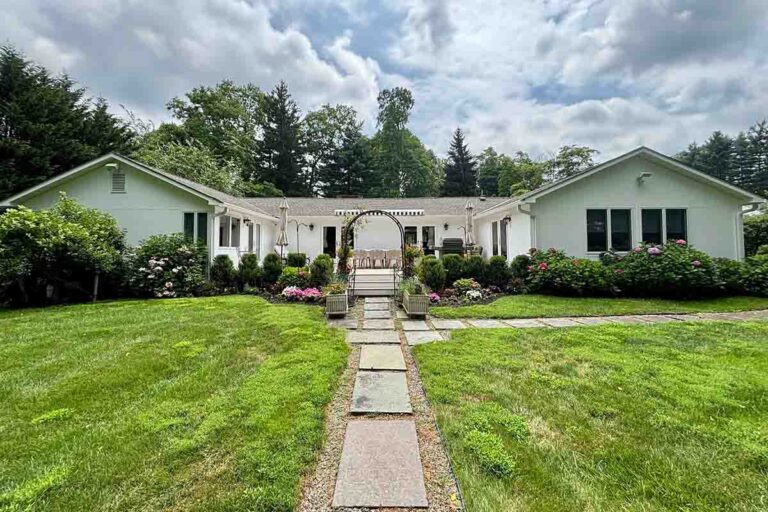 Single level home with green lawn taken from road